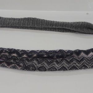 Two scarves, one gray, the other black, white, red, blue, gray